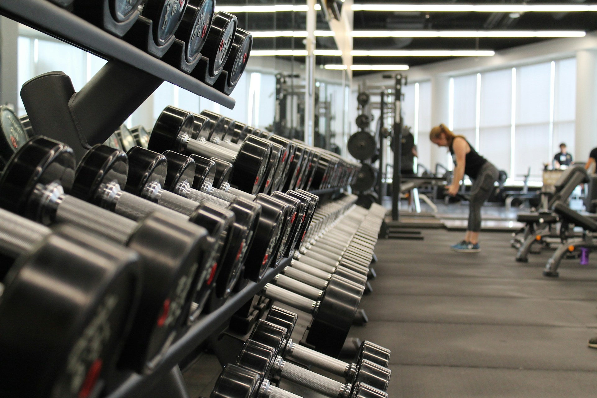 woman using dumbbells at the gym